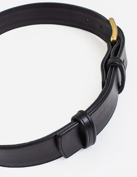 Black leather belt with golden buckle
